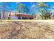 Spacious backyard with a brick house and a well-kept lawn, providing space for outdoor activities at 1650 Seayes Sw Rd, Mableton, GA 30126