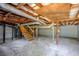 Exposed basement with wooden beams, concrete floors, and visible pipes, presenting a blank canvas at 1650 Seayes Sw Rd, Mableton, GA 30126