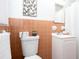 Traditional bathroom featuring a white vanity, mirror, and toilet with charming orange tiling at 1650 Seayes Sw Rd, Mableton, GA 30126
