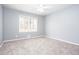 This bedroom features a large window for natural light and plush carpet at 1650 Seayes Sw Rd, Mableton, GA 30126