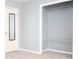 This bedroom features a wire-shelved closet and a door with a full-length mirror at 1650 Seayes Sw Rd, Mableton, GA 30126