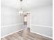 This dining room features an elegant light fixture and hardwood flooring at 1650 Seayes Sw Rd, Mableton, GA 30126