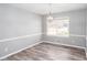 Dining area with modern light fixture, large window, and beautiful floors at 1650 Seayes Sw Rd, Mableton, GA 30126