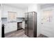 Modern kitchen featuring white cabinets, stainless steel appliances, and wood grain flooring at 1650 Seayes Sw Rd, Mableton, GA 30126