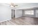 Spacious living room features wood grain floors, ceiling fan and light gray walls at 1650 Seayes Sw Rd, Mableton, GA 30126