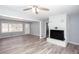Bright living room features wood grain flooring, brick fireplace, and soft gray walls at 1650 Seayes Sw Rd, Mableton, GA 30126