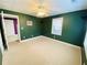 Empty bedroom featuring a ceiling fan, plush carpet, and neutral trim for a cozy feel at 11569 Findley Rd, Johns Creek, GA 30024