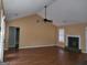 Bright living room boasts vaulted ceilings, a fireplace, and gleaming hardwood floors at 20 Tara Way, Covington, GA 30016