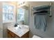 Cozy bathroom featuring a wooden vanity and chrome storage rack with towels at 2021 Austin Park Cir, Decatur, GA 30032