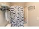 Bathroom features a shower/tub with a patterned curtain and a chrome storage rack at 2021 Austin Park Cir, Decatur, GA 30032