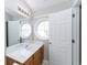 Well-lit bathroom with a large mirror and a unique circular window at 2021 Austin Park Cir, Decatur, GA 30032