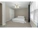 Bedroom boasts carpet flooring, a ceiling fan, and natural light from the windows at 2021 Austin Park Cir, Decatur, GA 30032