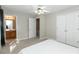 Bright bedroom featuring neutral walls, carpet flooring, and a ceiling fan with a full bathroom nearby at 2021 Austin Park Cir, Decatur, GA 30032