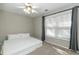 This simple bedroom has a light, airy vibe with carpet, a ceiling fan, and curtains at 2021 Austin Park Cir, Decatur, GA 30032