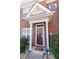 Close-up of the home's front door with white pillars and a security system at 2021 Austin Park Cir, Decatur, GA 30032