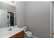 Clean powder room featuring a pedestal sink, toilet, and neutral wall color with laundry in the back at 2021 Austin Park Cir, Decatur, GA 30032