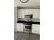 Kitchen showcasing stainless steel oven and microwave, along with white cabinets and gray walls at 2250 Camp Town Way, Lawrenceville, GA 30044