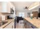 Modern kitchen open to living room featuring granite counters and stainless steel appliances at 612 Cedar Nw Ave, Atlanta, GA 30318