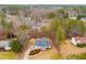 Aerial view of a charming home nestled among mature trees in a quiet neighborhood at 146 Adair Dr, Dallas, GA 30157