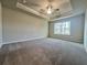 Unfurnished main bedroom featuring neutral carpet, trey ceiling and large window at 5515 Rock Place Ct # 45, Norcross, GA 30093