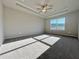 Large bedroom with carpet, ceiling fan, tray ceiling, and lots of natural light at 1312 Fern Ridge Ct # 78, Norcross, GA 30093