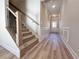 Foyer showcases wooden staircase, wood-look flooring, gray walls, and trim at 1312 Fern Ridge Ct # 78, Norcross, GA 30093