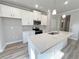 Modern kitchen with white cabinets, a large island, stainless steel appliances, and pendant lights at 1312 Fern Ridge Ct # 78, Norcross, GA 30093