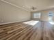 Bright living room featuring wood-look floors, large windows, and a modern ceiling fan at 1312 Fern Ridge Ct # 78, Norcross, GA 30093