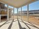 View of screened porch with concrete flooring and views of the backyard and adjacent townhomes at 1312 Fern Ridge Ct # 78, Norcross, GA 30093