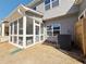 View of covered and screened porch with white trim, overhead lighting, and gray siding at 1312 Fern Ridge Ct # 78, Norcross, GA 30093