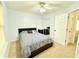 Inviting bedroom with plush carpet, ceiling fan, and natural light at 235 Windcroft Nw Ln, Acworth, GA 30101