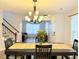 View of a dining room showcasing chandelier lighting, a staircase and access to the adjacent living area at 235 Windcroft Nw Ln, Acworth, GA 30101