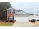 Two-story home with attached garage, brick accents, and manicured lawn at 235 Windcroft Nw Ln, Acworth, GA 30101