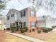 Two-story home with brick facade, vinyl siding, black shutters, and a garage at 235 Windcroft Nw Ln, Acworth, GA 30101