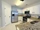 White kitchen featuring stainless steel appliances, granite countertops and a door to the outside at 235 Windcroft Nw Ln, Acworth, GA 30101