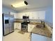 Well maintained kitchen boasting stainless steel appliances, granite countertops and white cabinetry at 235 Windcroft Nw Ln, Acworth, GA 30101