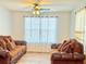 Comfortable living room with wood-look floors, ceiling fan, and cozy seating at 235 Windcroft Nw Ln, Acworth, GA 30101