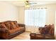 Cozy living room featuring wood-look floors, ceiling fan, and comfortable sofas at 235 Windcroft Nw Ln, Acworth, GA 30101