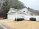 View of the rear exterior with vinyl siding, garage, and fenced yard at 235 Windcroft Nw Ln, Acworth, GA 30101