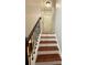 Elegant staircase showcasing dark-stained wooden steps and ornamental iron railings at 235 Windcroft Nw Ln, Acworth, GA 30101