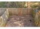 Enclosed backyard with a small garden area surrounded by a wooden fence at 2551 Bradford Ne Sq, Atlanta, GA 30345