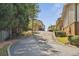 Street view of a community with townhomes and a winding road surrounded by lush greenery at 2551 Bradford Ne Sq, Atlanta, GA 30345