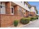 A brick townhouse exterior with green bushes and a black railing along the sidewalk at 2551 Bradford Ne Sq, Atlanta, GA 30345