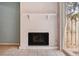 A close-up of a white brick fireplace and sliding glass doors leading to the backyard at 2551 Bradford Ne Sq, Atlanta, GA 30345