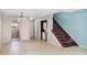 Open-concept living room features a staircase and laundry area with tile flooring throughout at 2551 Bradford Ne Sq, Atlanta, GA 30345