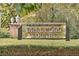 Community sign for Bradford Square, set among lush greenery, indicating a private condo community at 2551 Bradford Ne Sq, Atlanta, GA 30345