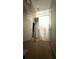 Hallway featuring neutral carpet, mirrored accent piece, and white doors at 3148 Glenloch Pl, Lawrenceville, GA 30044
