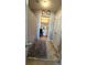 Hallway with gray rug, overhead lighting, and two doors leading to bath and closet at 3148 Glenloch Pl, Lawrenceville, GA 30044