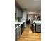 Open-concept kitchen with stainless steel appliances and view to dining and living area at 3148 Glenloch Pl, Lawrenceville, GA 30044