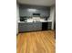 Updated kitchen features gray cabinets, stainless steel appliances, and hardwood floors at 3148 Glenloch Pl, Lawrenceville, GA 30044